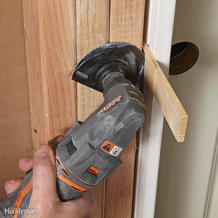 Trim wooden door shims with an oscillating tool
