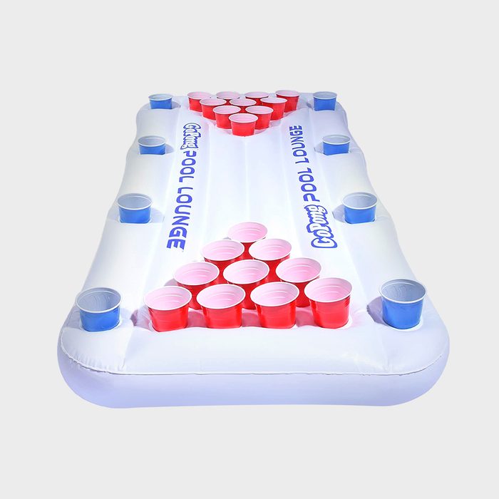An inflatable lounge features a triangular formation of red and blue cups on a white surface, designed for a pool party game setup.