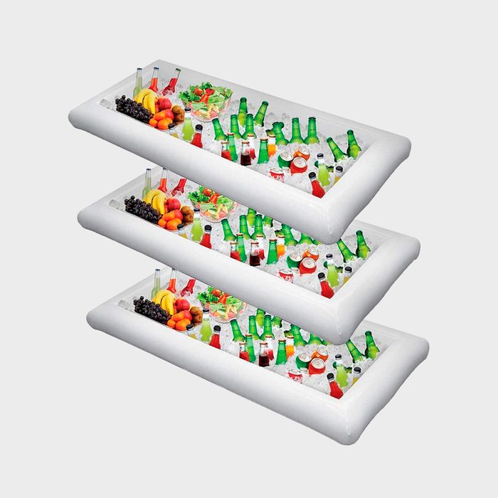 Three stacked trays filled with ice display various beverages and fruits, set against a simple background, ready for a gathering or party.