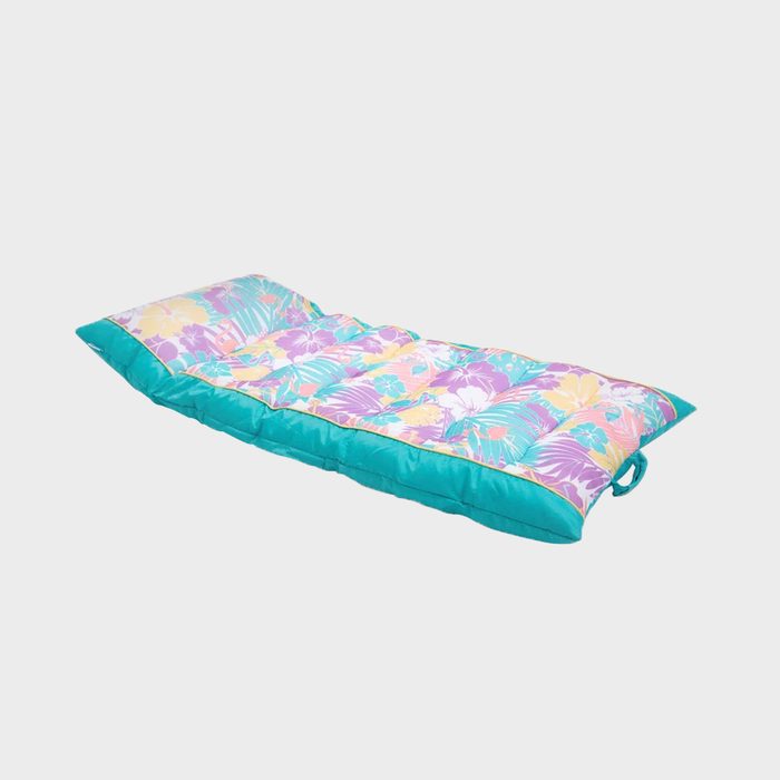 A colorful, patterned mattress pad rests flat on a neutral surface, designed for relaxation or outdoor use, featuring vibrant floral designs in shades of pink and blue.