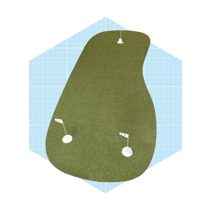 A putting green features two holes for golf practice, situated on a textured, green surface, set against a light grid background.