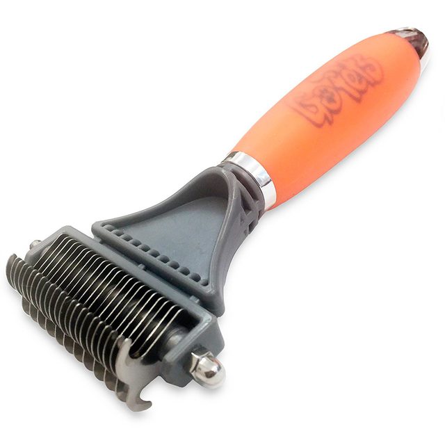 A grooming tool with a textured orange handle removes loose fur using fine metal teeth, intended for use on pets in a home setting.