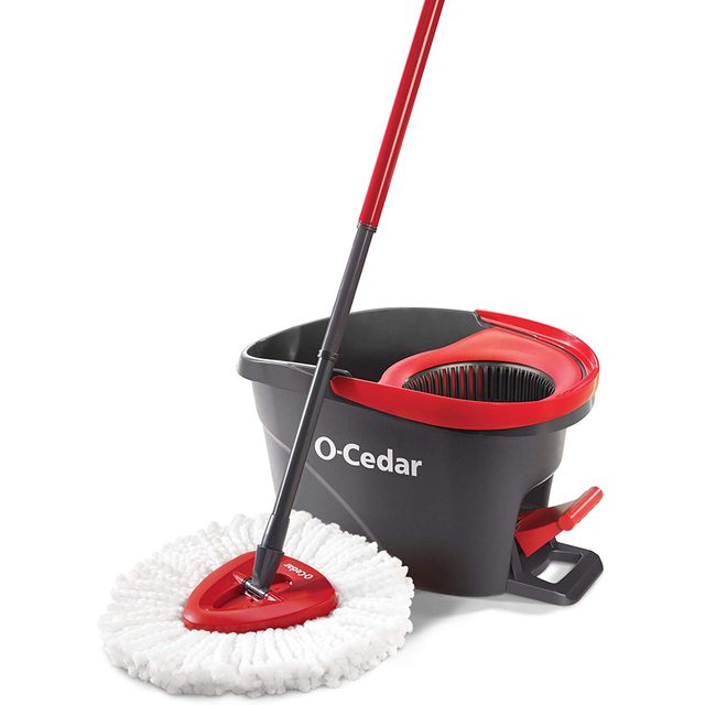 A mop with a white head is positioned over a gray and red bucket. The bucket features a wringer and the brand 