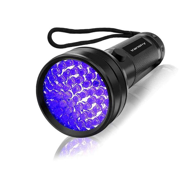 A black flashlight with a circular head emits blue light, showcasing multiple small bulbs, designed for illuminating areas in low visibility settings.