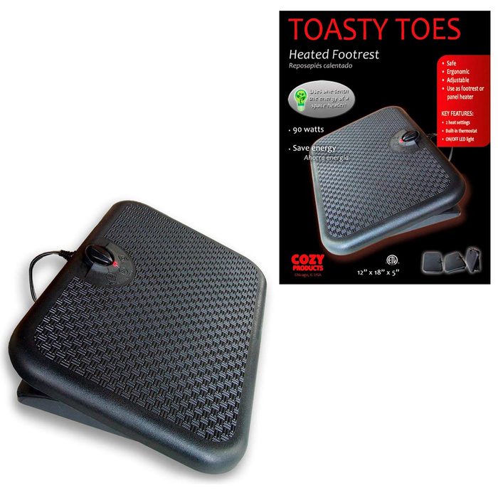 A heated footrest sits on a surface, providing warmth. It features an adjustable thermostat and is designed for ergonomic comfort in cold environments.