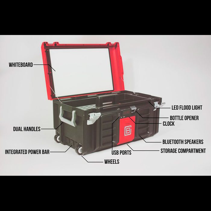A black and red toolbox with dual handles, wheels, and a whiteboard lid displays various features like USB ports, Bluetooth speakers, and a bottle opener.