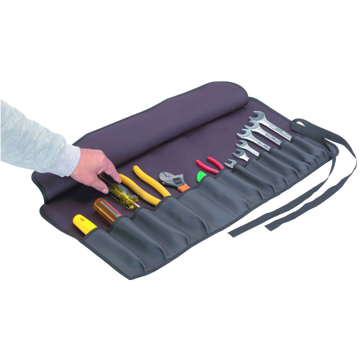 A hand reaches for a yellow tool from an organized tool roll, which displays various hand tools, resting on a flat surface.