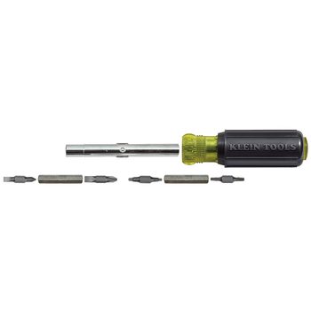 A screwdriver with interchangeable bits lies on a white surface, ready for use, showcasing its various attachments for different screw types.