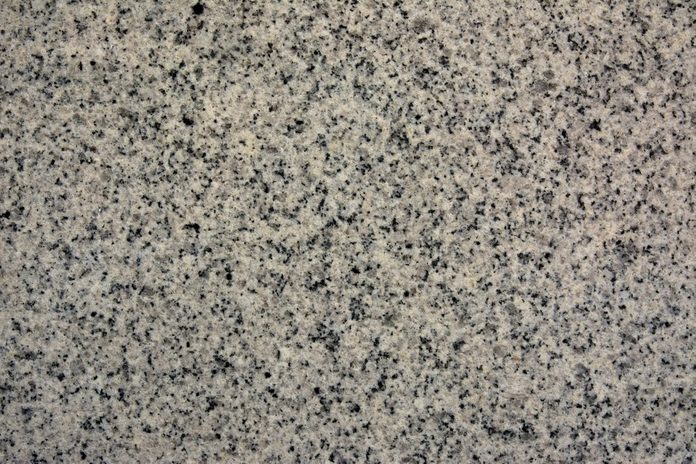 Polished granite texture with pink hues and black