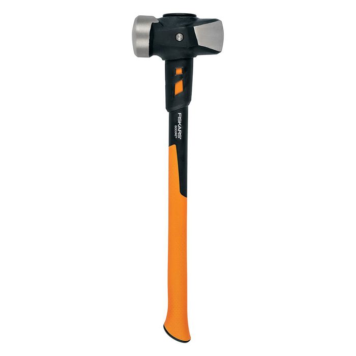 A rubber mallet stands upright, showcasing a black head with a silver striking surface and an orange handle, likely for striking surfaces without causing damage.