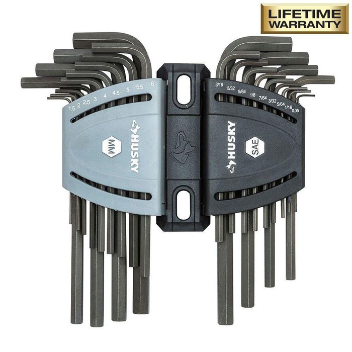 A set of hex keys is arranged in two groups, labeled metric and SAE, attached to a central holder, featuring a lifetime warranty badge.