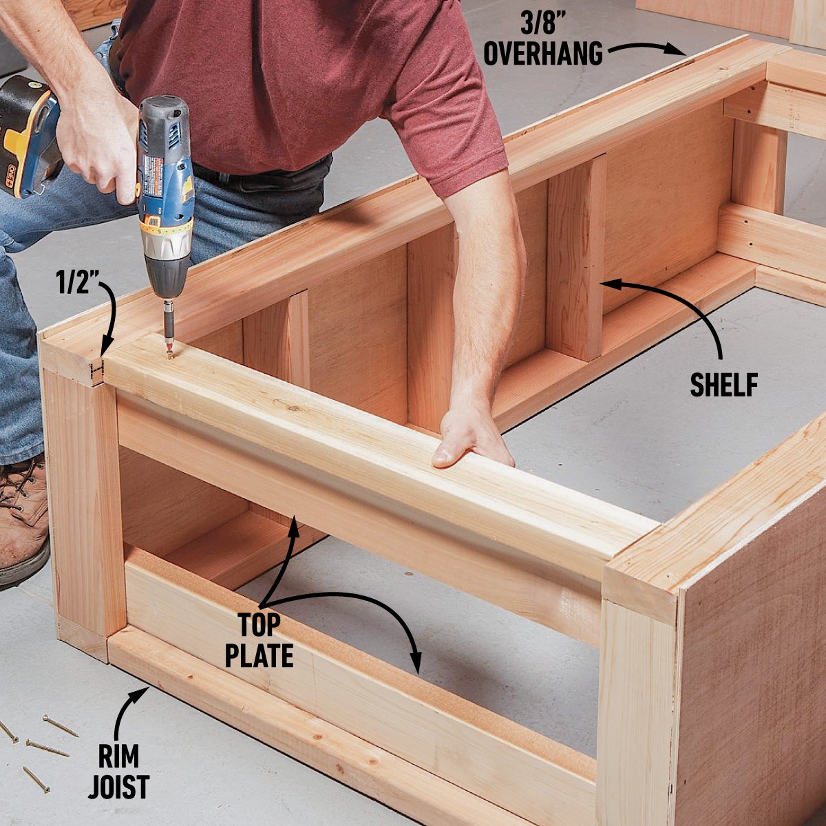 A person drills a screw into a wooden structure, assembling a shelf within a framework, in a workshop setting with wooden materials and tools visible.