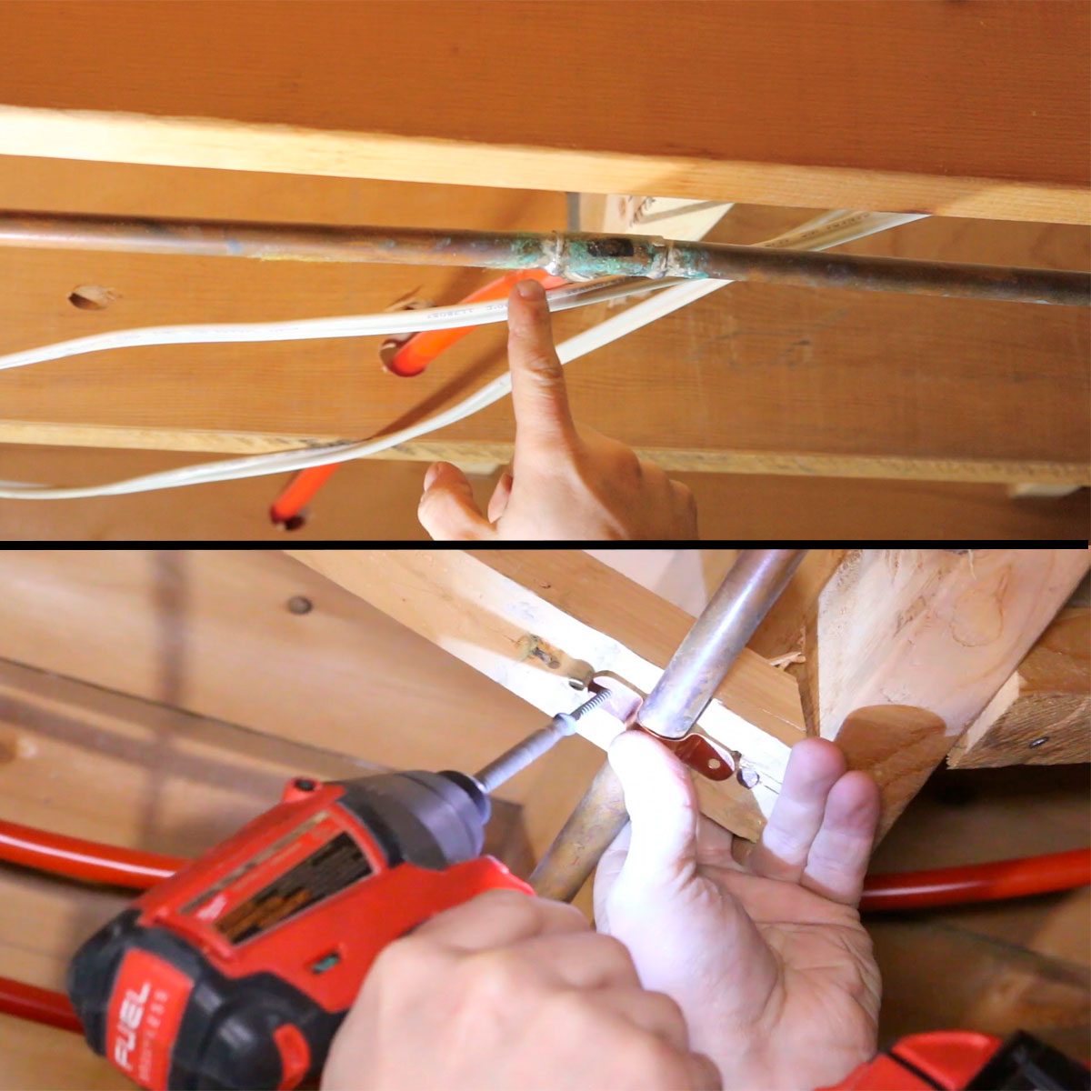 A hand points at a copper pipe with green corrosion while another hand uses a power drill to secure a pipe fitting in a wooden framework.