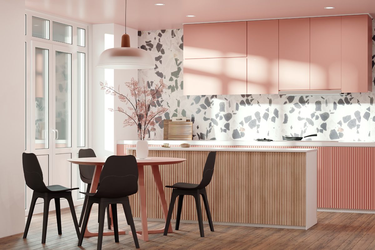 A round pink table sits surrounded by black chairs in a modern kitchen, featuring pastel cabinets, a patterned backsplash, and large windows letting in natural light.