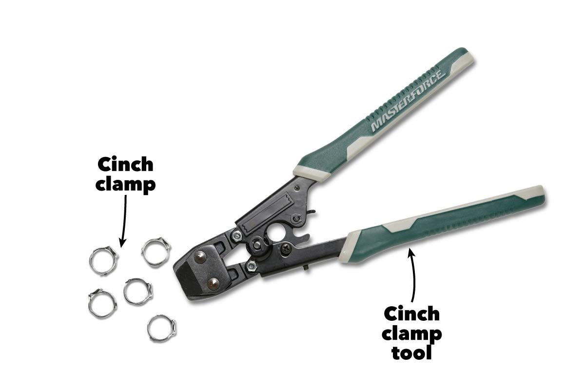 A cinch clamp tool lies open beside several cinch clamps, designed for securing connections in various applications, presented against a plain white background.