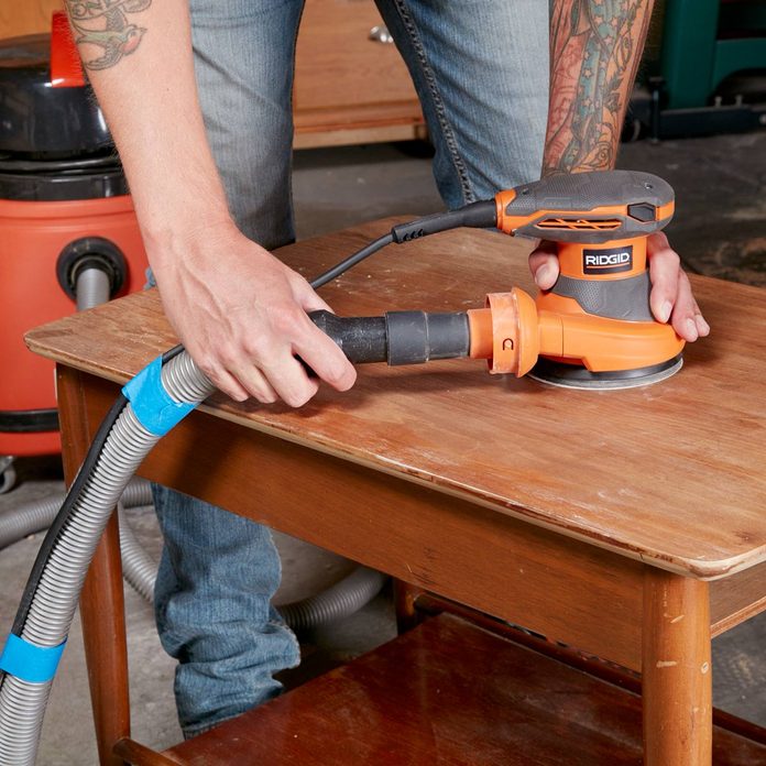 Shop-vacuum-hooked-up-to-random-orbit-sander