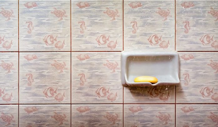 A Used Bar Soap on a Soap Tray in the Shower
