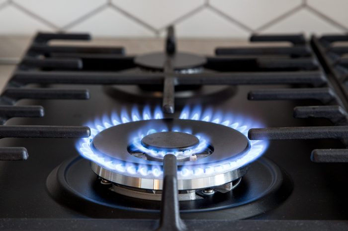 Gas burner on black modern kitchen stove. kitchen gas cooker with burning fire propane gas