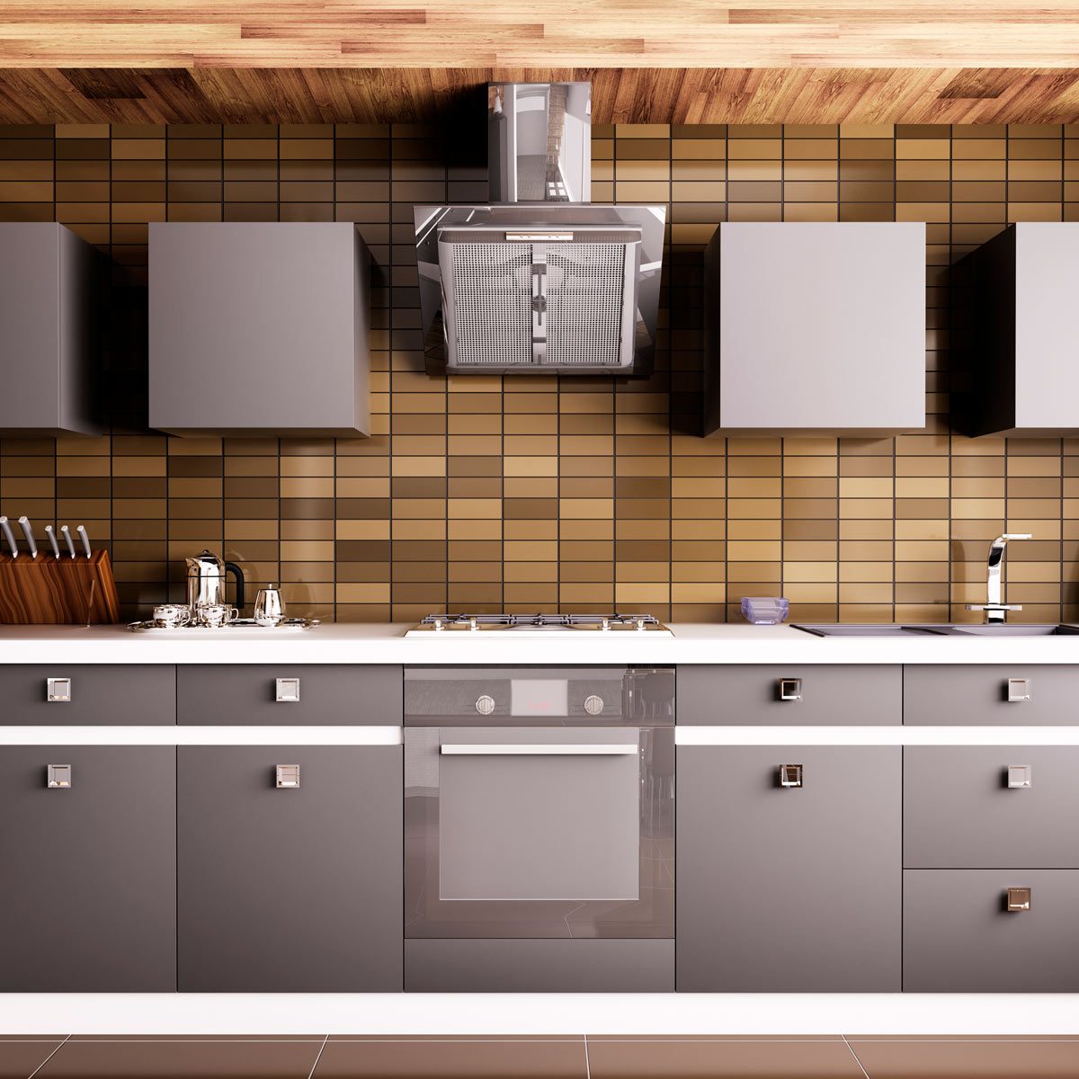 A modern kitchen features sleek gray cabinetry, a stainless steel hood, and a cooktop, set against a brown tiled wall.