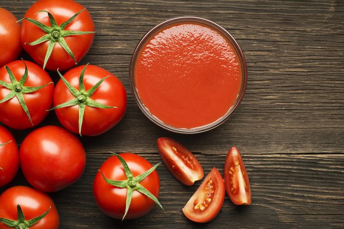 Fresh cherry tomato sauce on rustic wooden background