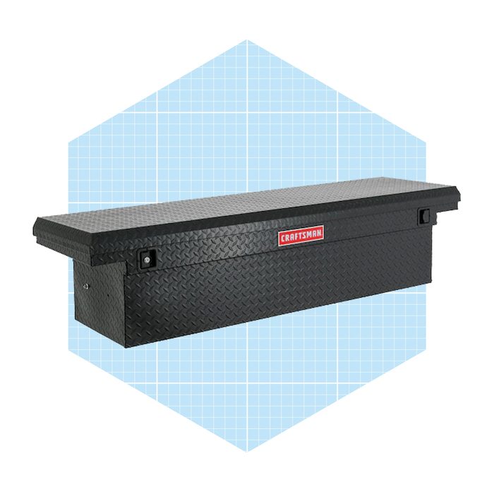 A black, diamond-patterned storage chest sits on a light blue grid background, designed to securely store tools and equipment.