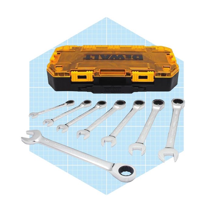 A yellow-and-black tool case holds several silver wrenches, arranged neatly in front, set against a blue grid background.