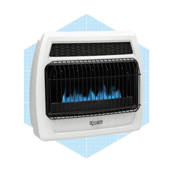 A wall-mounted gas heater emits blue flames, providing warmth. It features a protective grill and is set against a light blue patterned background.