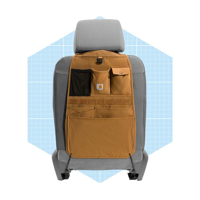 A brown car seat back organizer hangs on a gray seat, featuring various pockets and storage compartments against a light blue grid background.