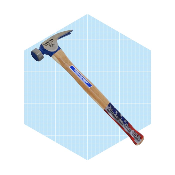A steel hammer with a wooden handle rests against a light blue grid background, displaying “Vaughn” and “Made in the USA” along its sides.