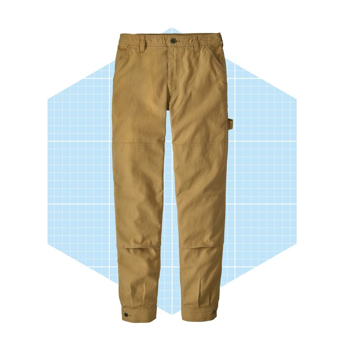 Tan work pants display a straight-cut design and side pocket, positioned against a light blue geometric background.