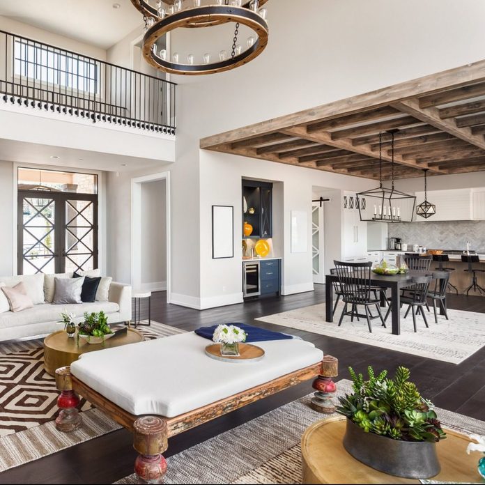 Stunning Panorama of Luxury Home Interior with Open Concept Floor Plan: Shows Living Room, Dining Room, Kitchen, and Entry. Elegant Stairs Lead up to Second Story.