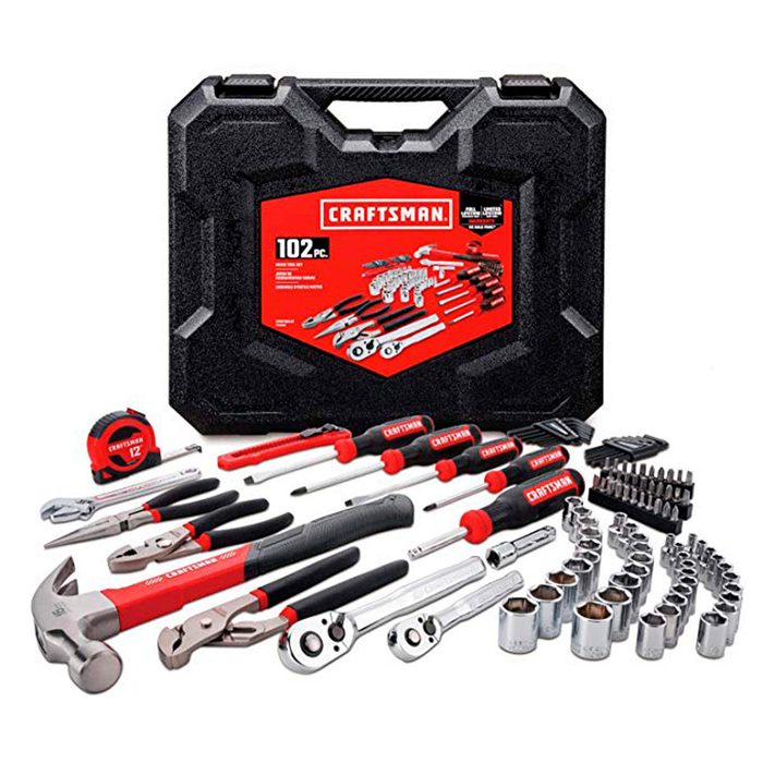 A black tool case displays a variety of hand tools, including wrenches, pliers, and a hammer, arranged neatly on a flat surface.