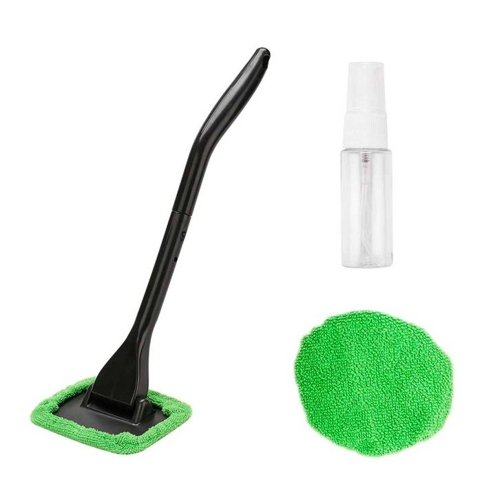 A black cleaning tool with a green microfiber pad is positioned beside a clear spray bottle. It's ready for use in cleaning tasks.