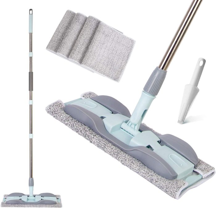 A cleaning mop with a detachable head stands upright. Three microfiber pads and a scraper tool are placed nearby for maintenance and efficient cleaning.