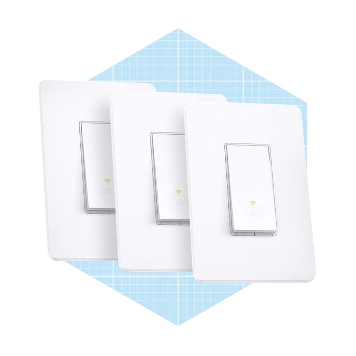 Three smart light switches are positioned in front of a light blue grid background, indicating connectivity and modern design for home automation.