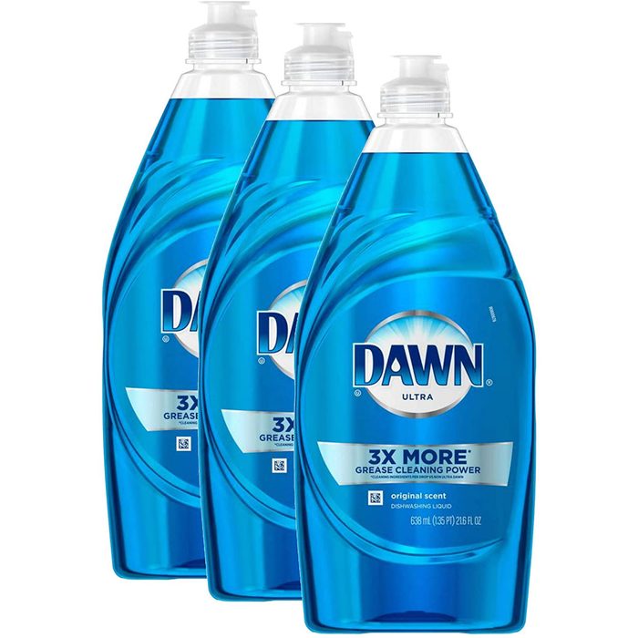 Three bottles of blue dishwashing liquid stand upright. Each bottle features a pump top and labels highlighting grease-cleaning power and original scent.