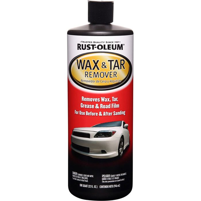 A bottle of Rust-Oleum wax and tar remover, labeled to remove wax, tar, grease, and road film, intended for use before and after sanding.