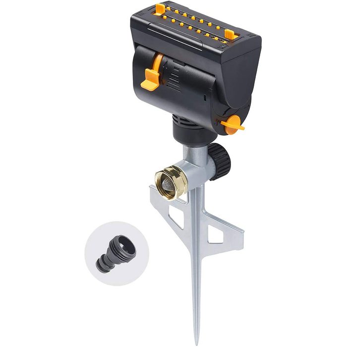 A sprinkler head is positioned on a stake, projecting water. It features adjustable controls and connects to a garden hose for irrigation in outdoor settings.