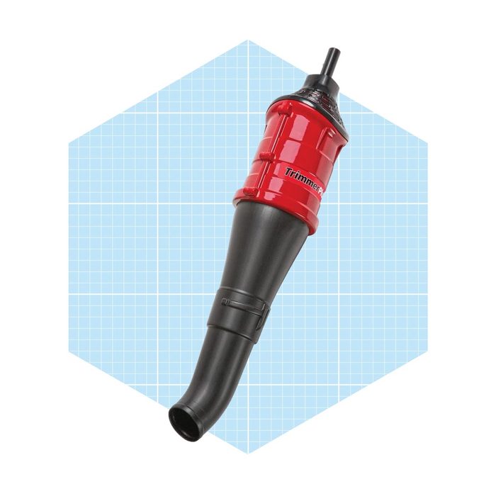 A handheld trimmer with a red and black design rests against a light blue grid background, suggesting a tool for precision cutting in gardening or crafts.