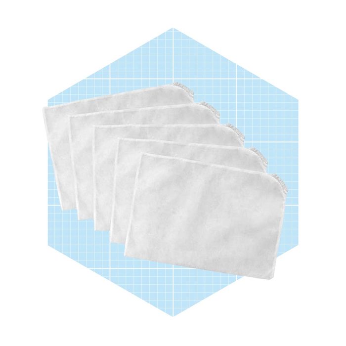 Five white fabric pouches are stacked with lace trim, displayed on a light blue, grid-patterned background. They appear soft and slightly wrinkled.