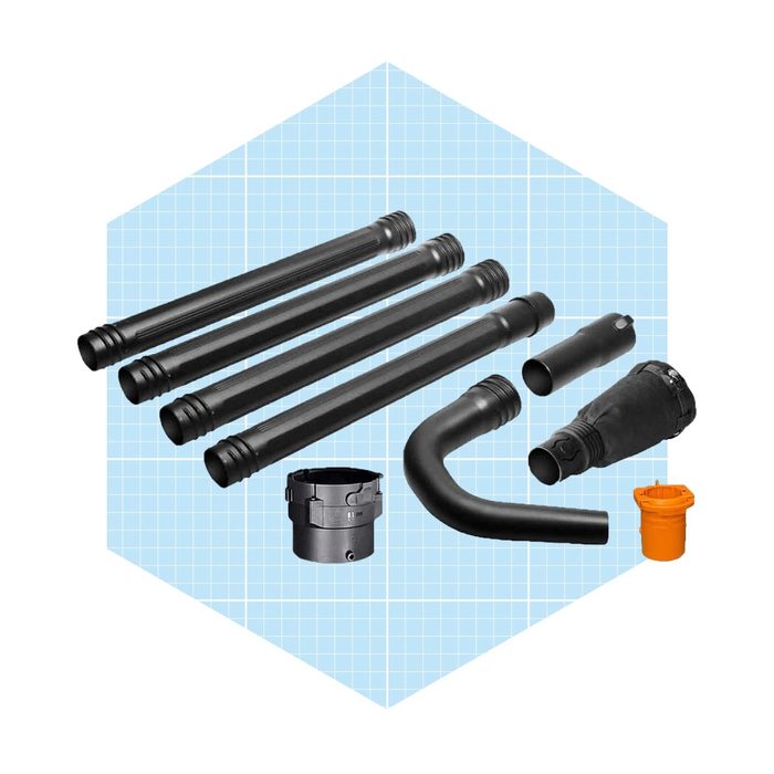 Black plumbing pipes and fittings are arranged on a light blue grid background, illustrating components used in fluid transport or drainage systems.
