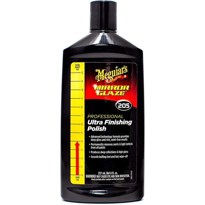 A black bottle of Meguiar's Ultra Finishing Polish stands upright, indicating a specialized formula for achieving high gloss on vehicle paint finishes.