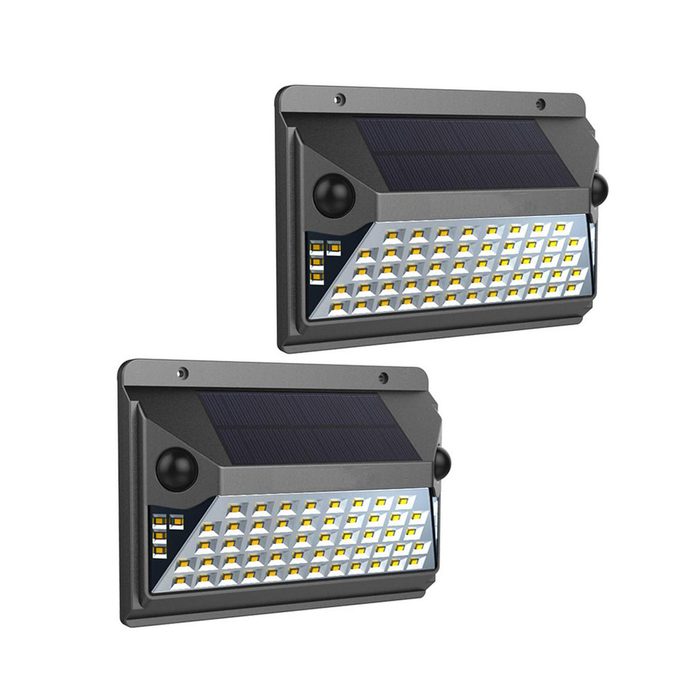 Two solar-powered LED lights are mounted on a surface, actively illuminating an outdoor area, designed for security and visibility at night.