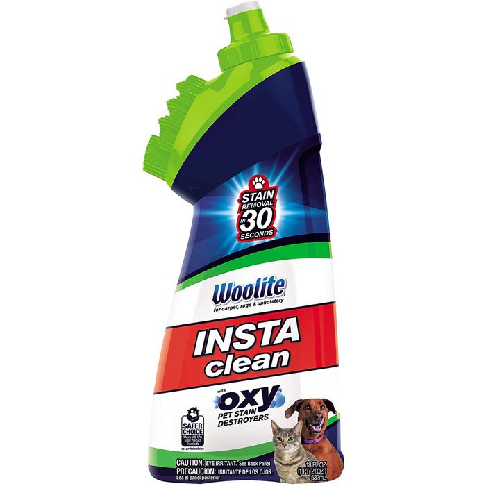 A spray bottle of Woolite InstaClean is displayed, labeled for pet stain removal in 30 seconds, with images of a cat and dog on the front.