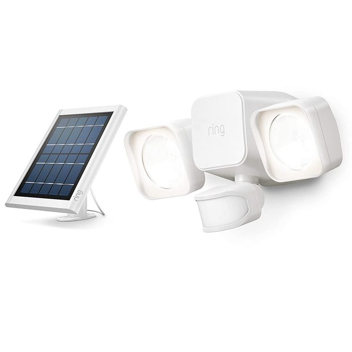 A white motion-activated security light with dual bright bulbs and a sensor is positioned beside a solar panel, designed for outdoor installation.