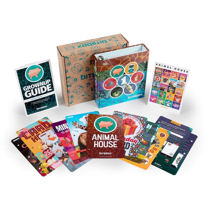 A colorful box with programming cards and a guide presents various themed activities, laid out on a white background, encouraging learning and creativity.