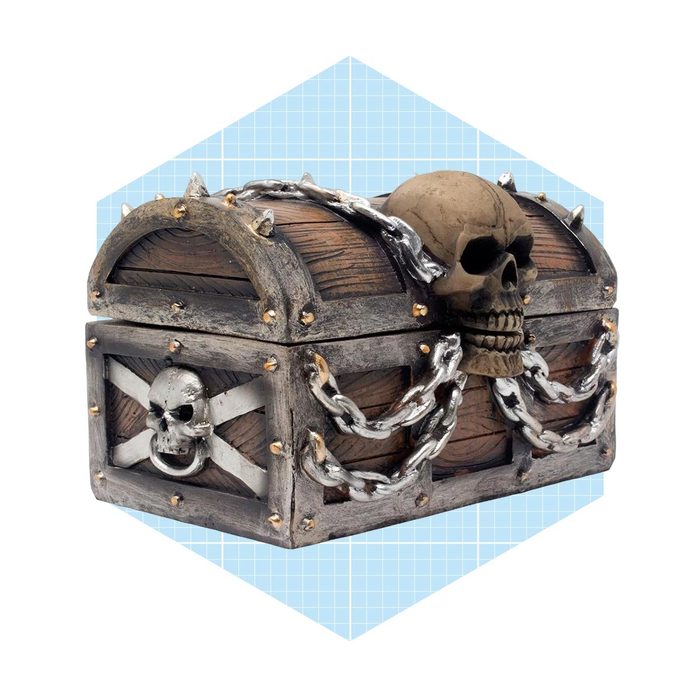 A decorative treasure chest, adorned with skulls and chains, is positioned against a blue geometric background, evoking themes of adventure and mystery.