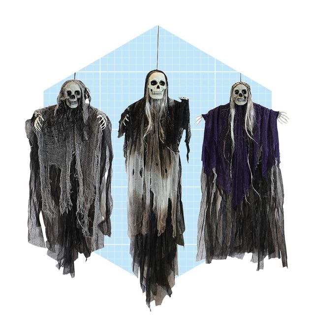 Three hanging skeleton figures wear tattered robes, each displaying a skull face and long hair, against a light blue, grid-patterned background.