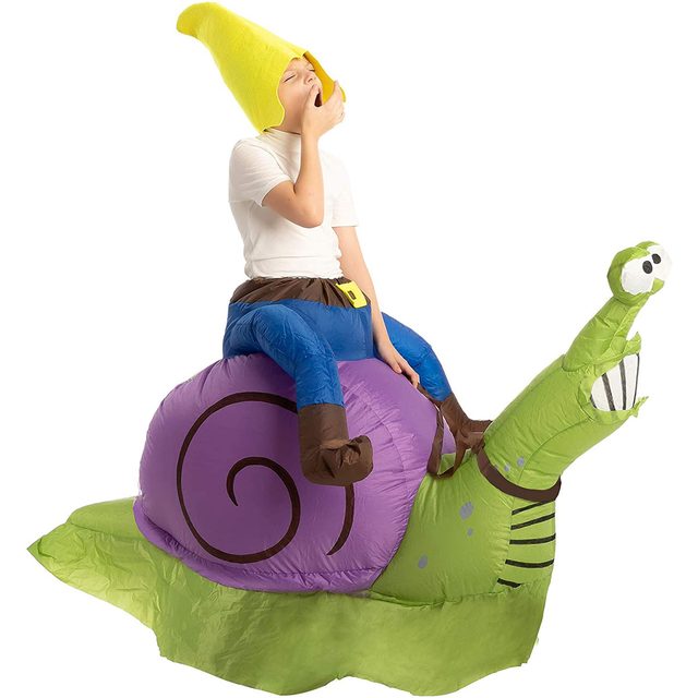 A child in a yellow hat sits on a large purple inflatable snail, yawning while wearing a white shirt and blue pants, in a bright environment.
