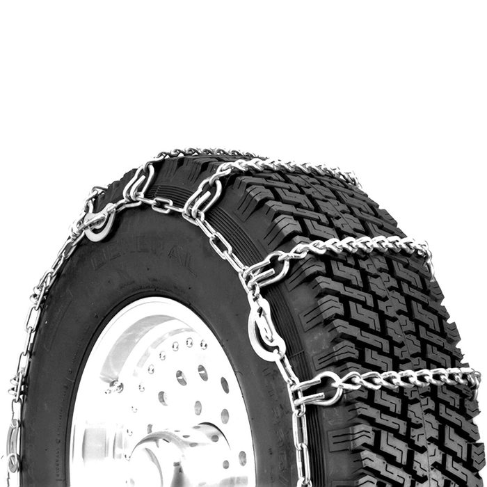 A tire equipped with metal chains is positioned upright, designed for enhanced traction. The chains securely wrap around the tread, indicating suitability for snowy conditions.